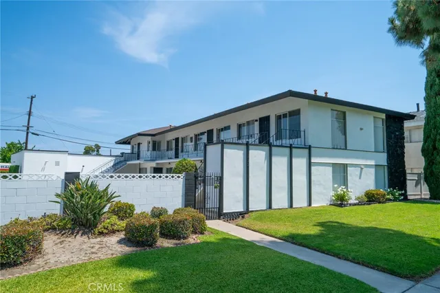 a front view of a house with a garden and yard