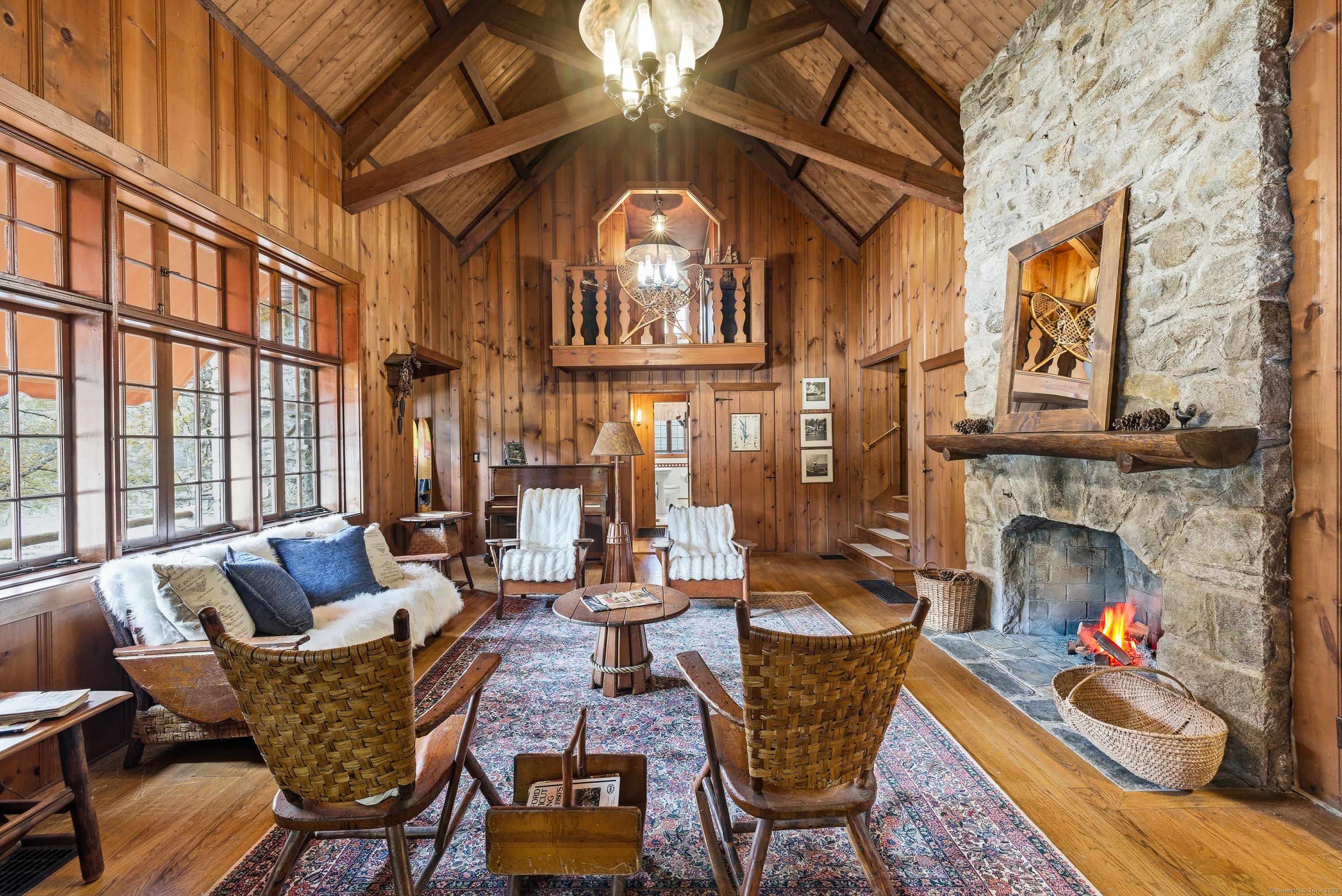 23 Echo Drive New Milford, CT 06776 - Photo 15 of 38 a living room with furniture a fireplace and a floor to ceiling window