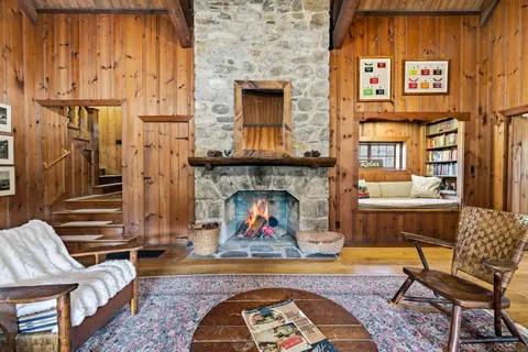 a living room with furniture a fireplace and wooden floor
