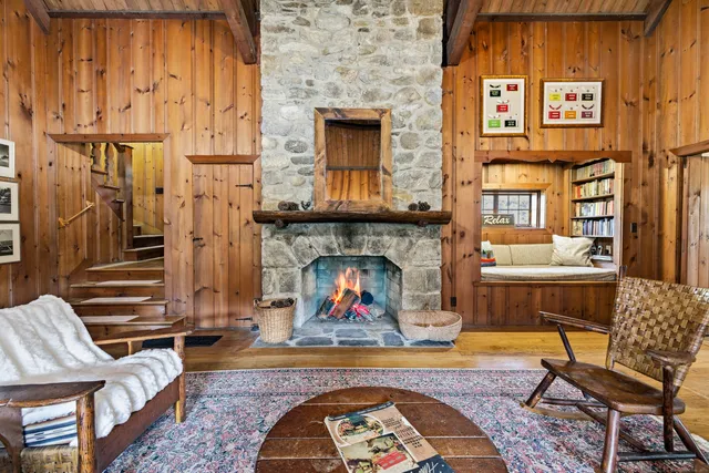 a living room with furniture a fireplace and wooden floor