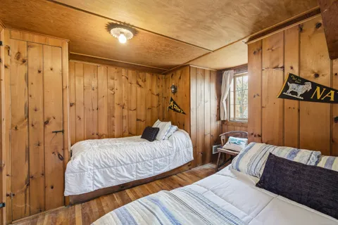 a bedroom with two beds and painted walls