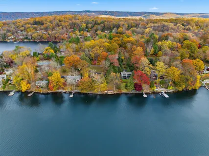 a blue swimming pool is sitting in the middle of a lake
