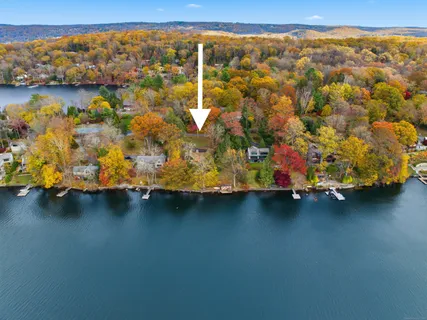 a blue swimming pool with lawn chairs