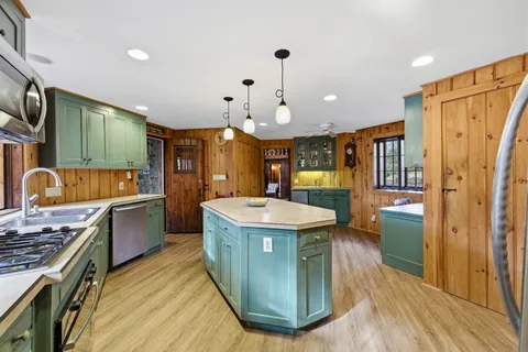 a kitchen with stainless steel appliances granite countertop a stove and a refrigerator