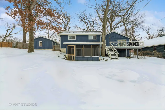 a front view of a house with a yard covered in snow