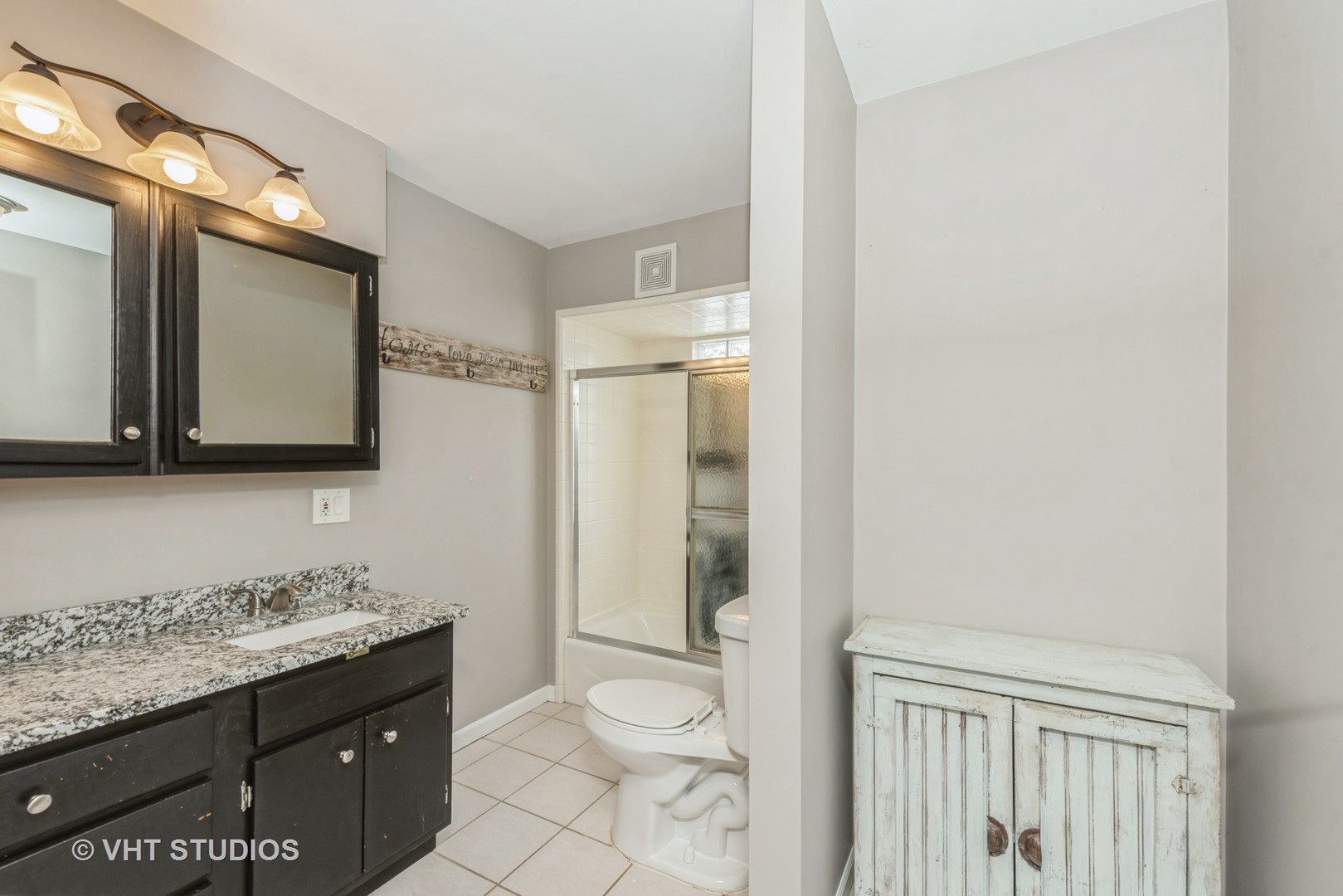 7712 Cedar Road Wonder Lake, IL 60097 - Photo 3 of 19 a bathroom with a granite countertop sink toilet and shower