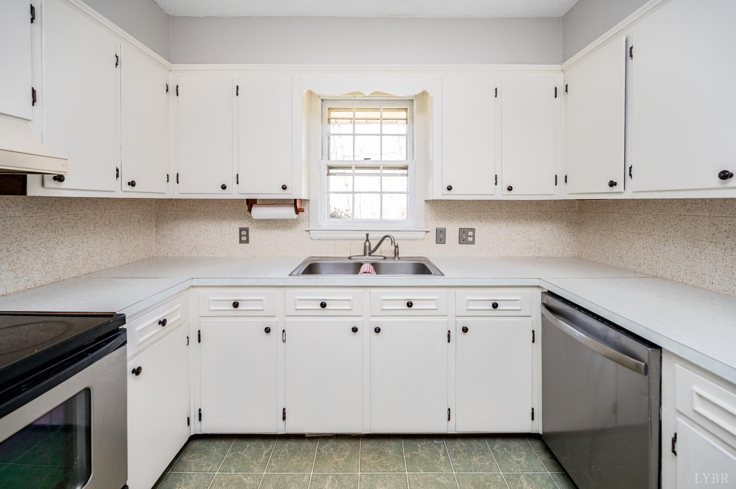 527 Gough Road Rustburg, VA 24588 - Photo 14 of 59 a kitchen with cabinets appliances a sink and a window