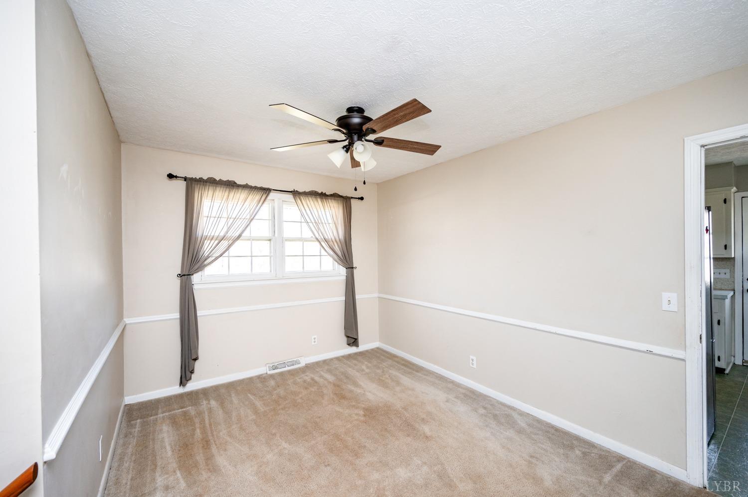527 Gough Road Rustburg, VA 24588 - Photo 17 of 59 a view of an empty room and a chandelier fan
