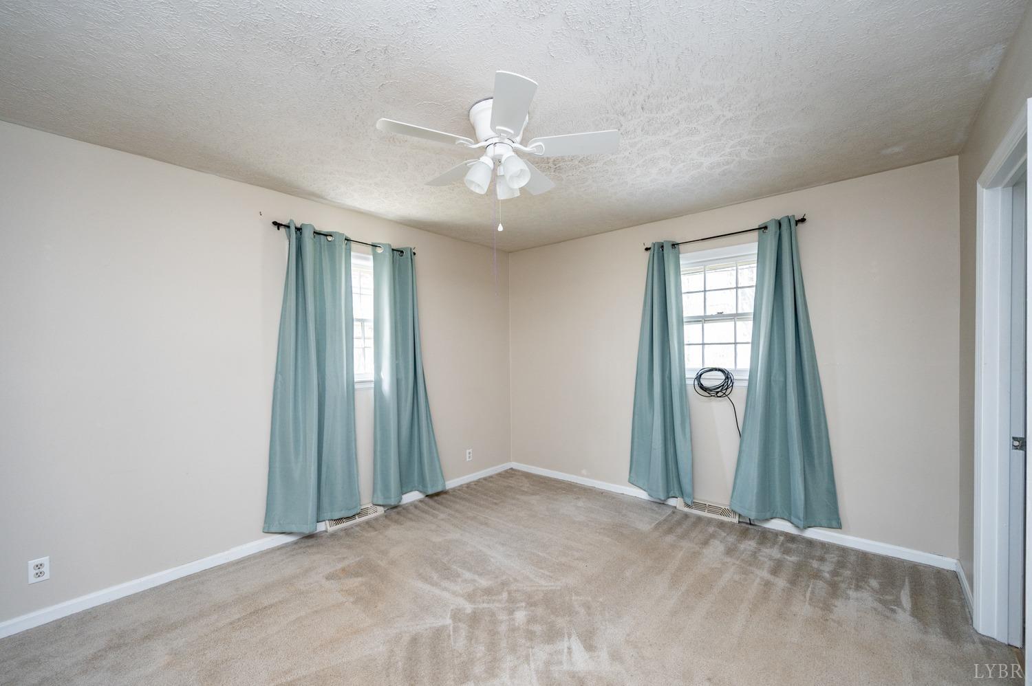 527 Gough Road Rustburg, VA 24588 - Photo 20 of 59 an empty room with closet and a chandelier fan