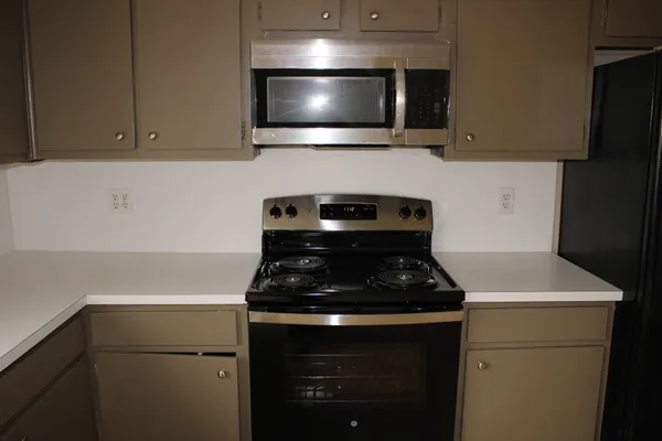 a kitchen with a stove and a microwave