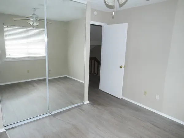 an empty room with wooden floor and a window