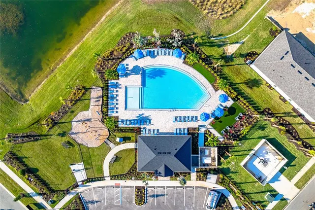 a view of a swimming pool with outdoor seating
