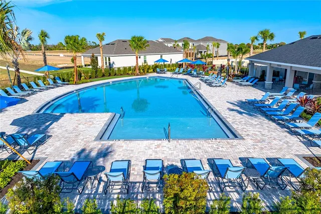 a view of a swimming pool with an outdoor seating