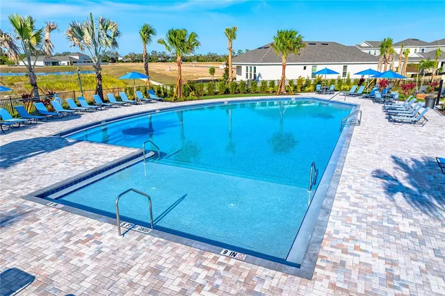 a view of a house with swimming pool and sitting area