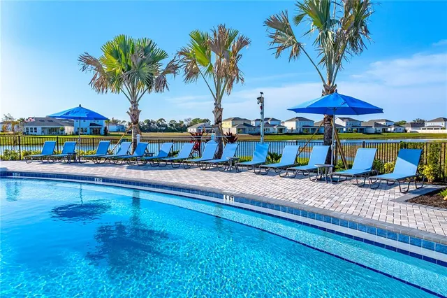 a view of a swimming pool with an outdoor seating