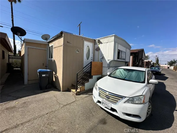 a bedroom with furniture and a flat screen tv