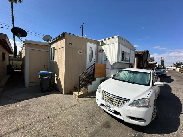 a bedroom with furniture and a flat screen tv