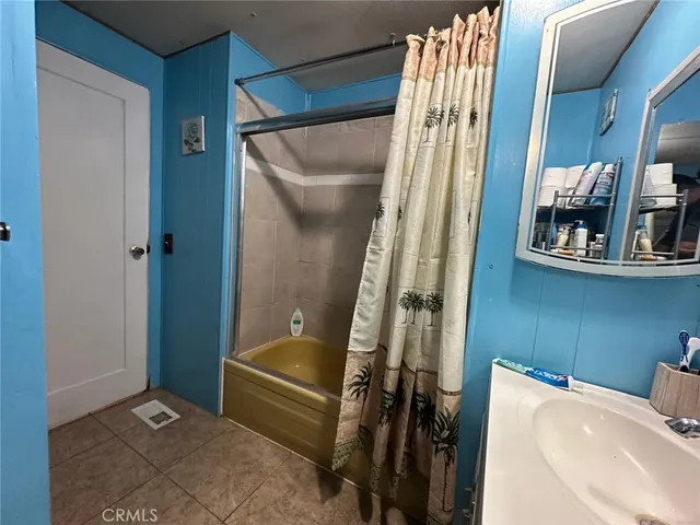 a bathroom with a tub and shower