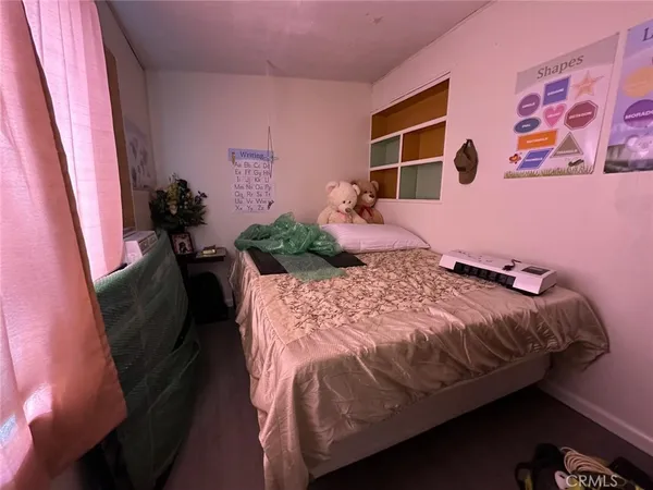 a bed sitting in a bedroom next to a window