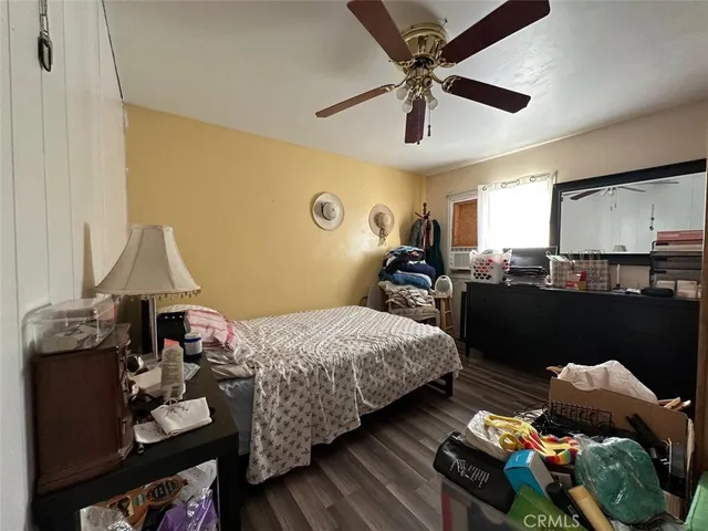 a bedroom with bed and a chandelier