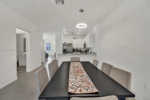 a large kitchen with cabinets and wooden floor