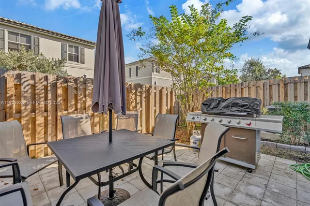 a view of a house with backyard and sitting area