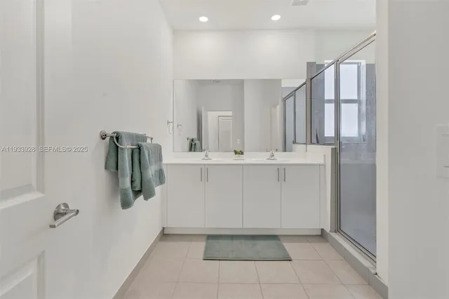 a bathroom with double sink and a mirror