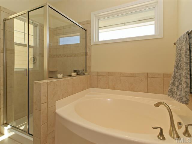 1403 Van Page Boulevard Raleigh, NC 27607 - Photo 17 of 25 a bathroom with a bathtub and shower