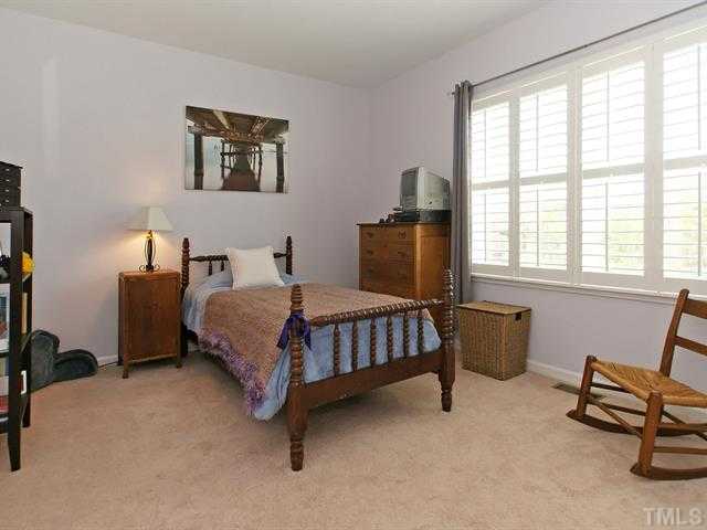 1403 Van Page Boulevard Raleigh, NC 27607 - Photo 19 of 25 a bedroom with a bed chair and two windows