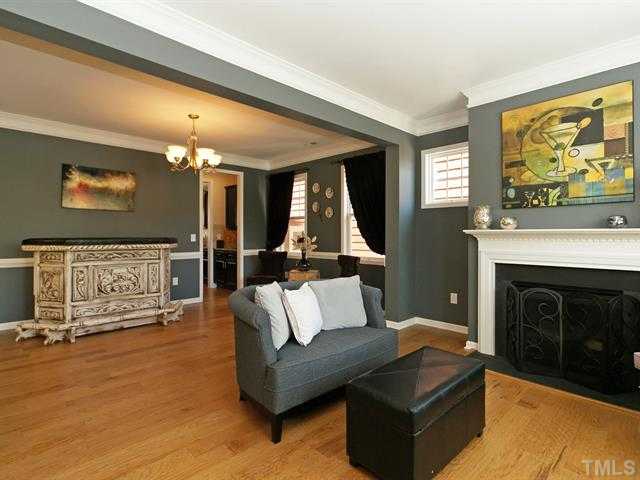 1403 Van Page Boulevard Raleigh, NC 27607 - Photo 5 of 25 a living room with furniture a fireplace and a flat screen tv