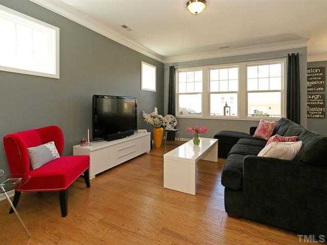 1403 Van Page Boulevard Raleigh, NC 27607 - Photo 7 of 25 a living room with furniture and a flat screen tv