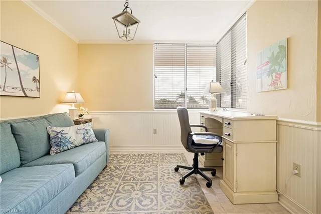 a view of a livingroom with workspace and a couch