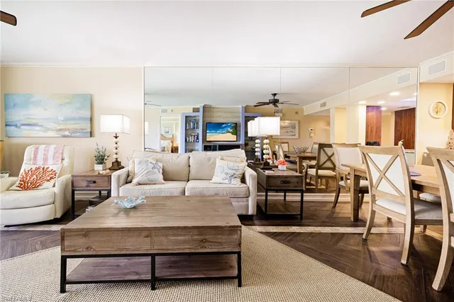 a living room with furniture and a dining table with kitchen view