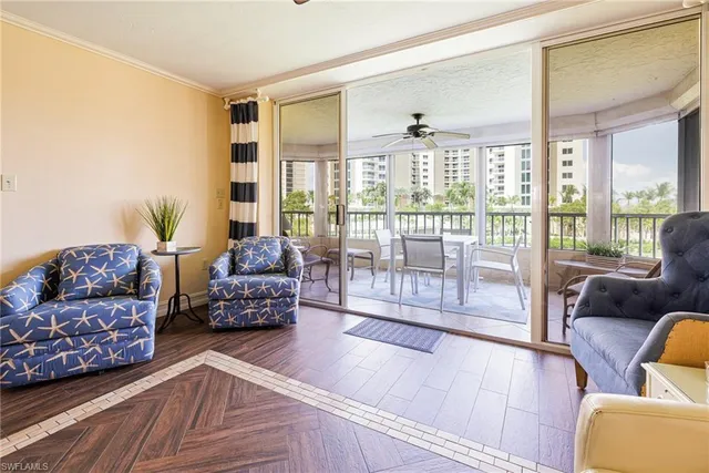 a bedroom with furniture and large windows
