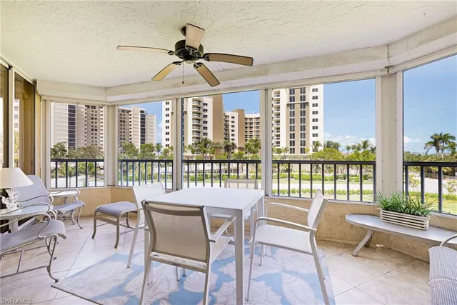 a dining room with furniture a chandelier and wooden floor