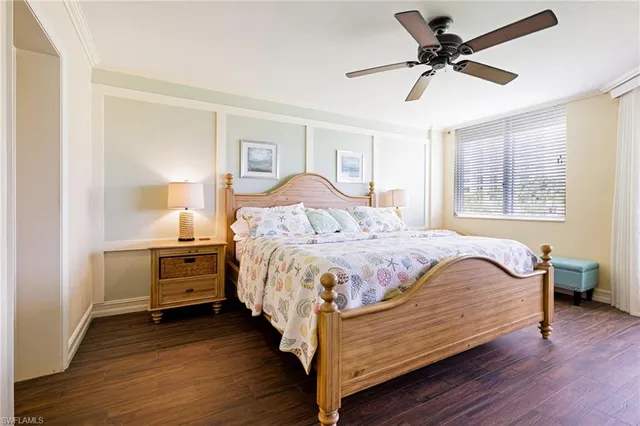 a spacious bedroom with a bed and a chandelier