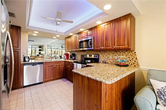 a kitchen with a sink refrigerator and microwave
