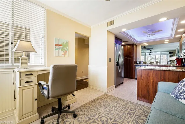 a livingroom with workspace and a window