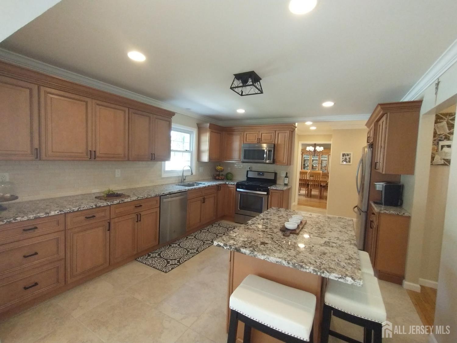 18 Timber Road East Brunswick, NJ 08816 - Photo 12 of 38 a kitchen with refrigerator cabinets dining table and chairs