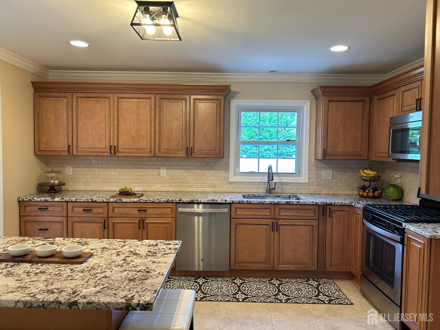 18 Timber Road East Brunswick, NJ 08816 - Photo 13 of 38 a kitchen with stainless steel appliances granite countertop a stove sink and cabinets