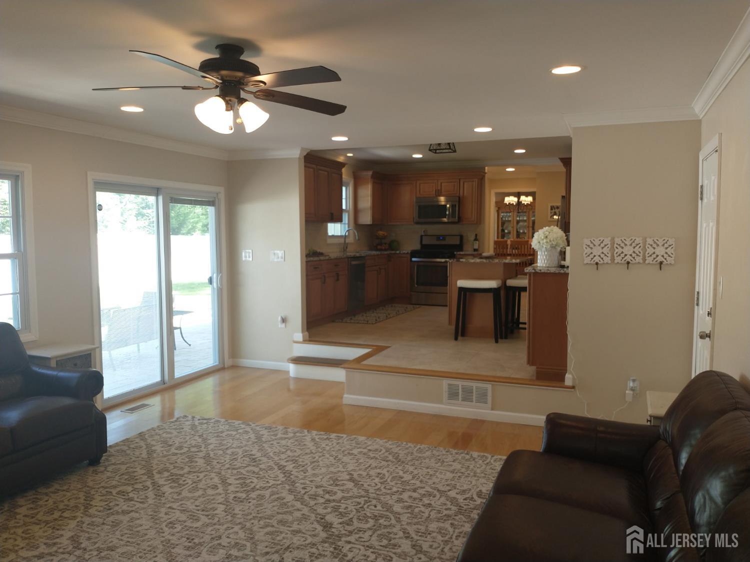 18 Timber Road East Brunswick, NJ 08816 - Photo 15 of 38 a living room with furniture and a chandelier