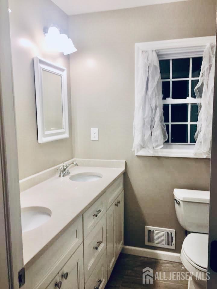 18 Timber Road East Brunswick, NJ 08816 - Photo 20 of 38 a bathroom with a granite countertop toilet sink and mirror