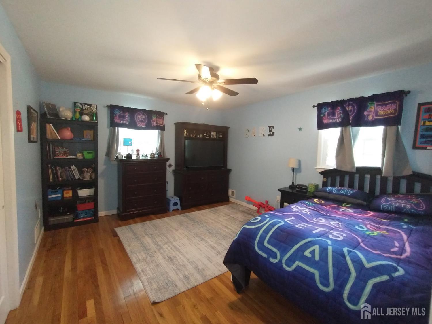 18 Timber Road East Brunswick, NJ 08816 - Photo 21 of 38 a bedroom with a large bed and a chandelier