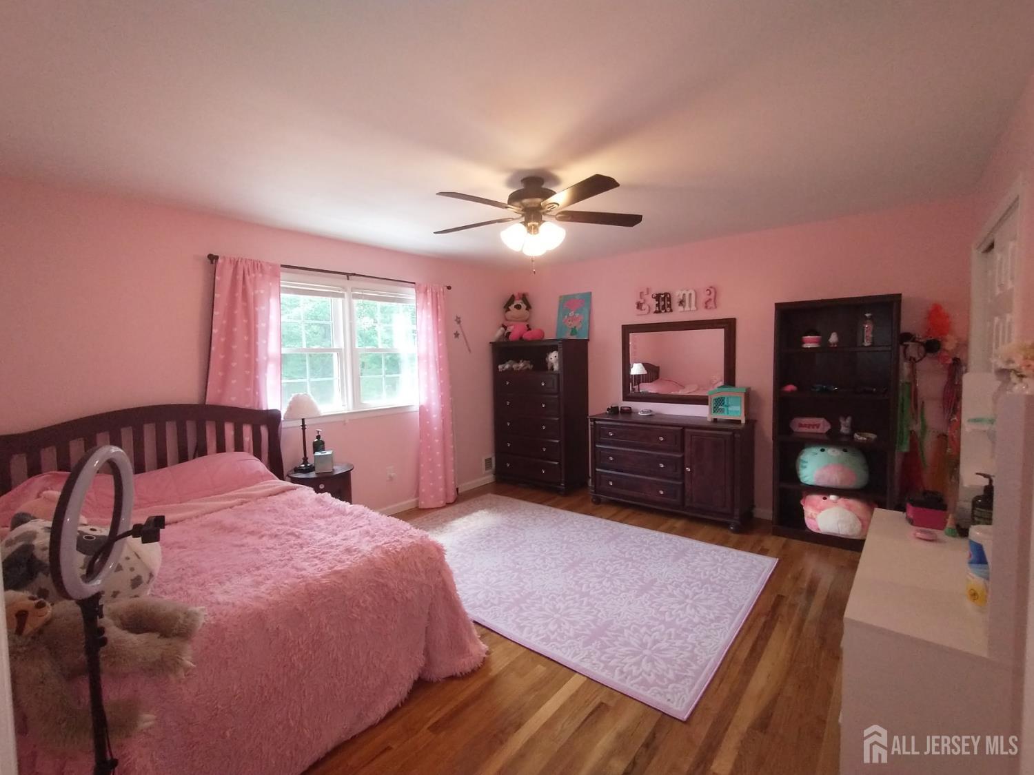 18 Timber Road East Brunswick, NJ 08816 - Photo 22 of 38 a spacious bedroom with a bed a dresser and a chandelier