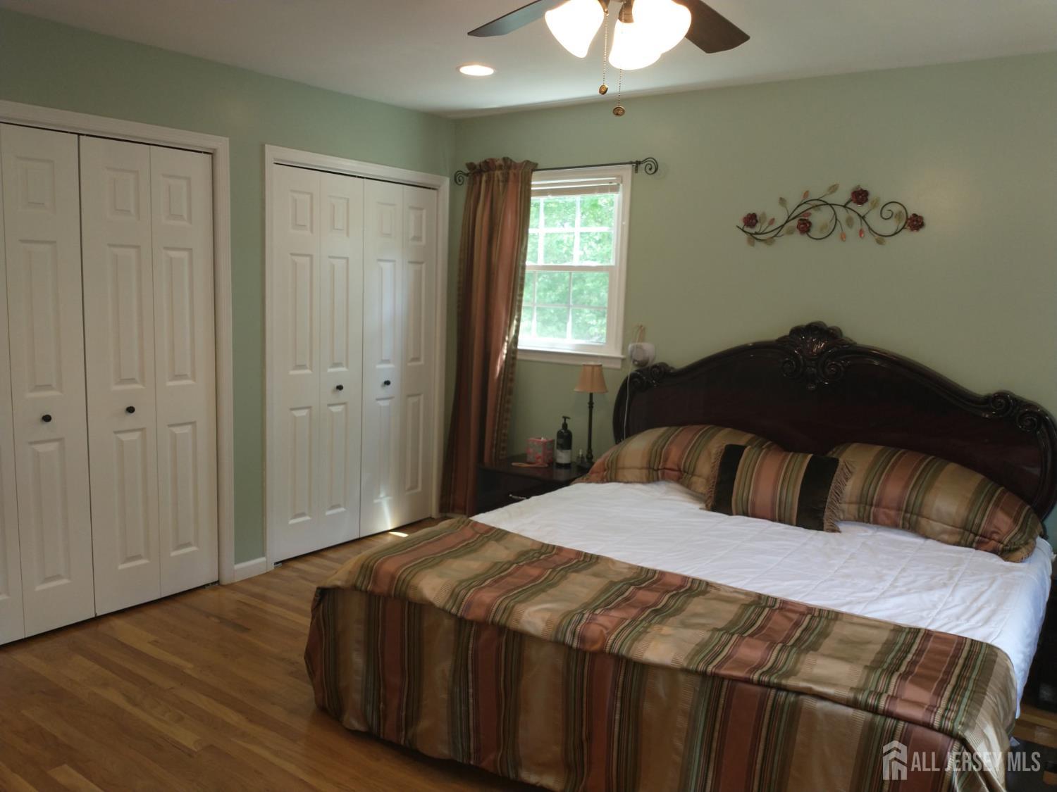 18 Timber Road East Brunswick, NJ 08816 - Photo 24 of 38 a bedroom with a bed and a chandelier