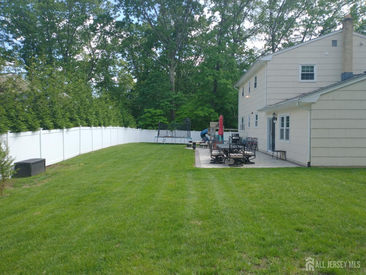 18 Timber Road East Brunswick, NJ 08816 - Photo 29 of 38 a backyard of a house with table and chairs