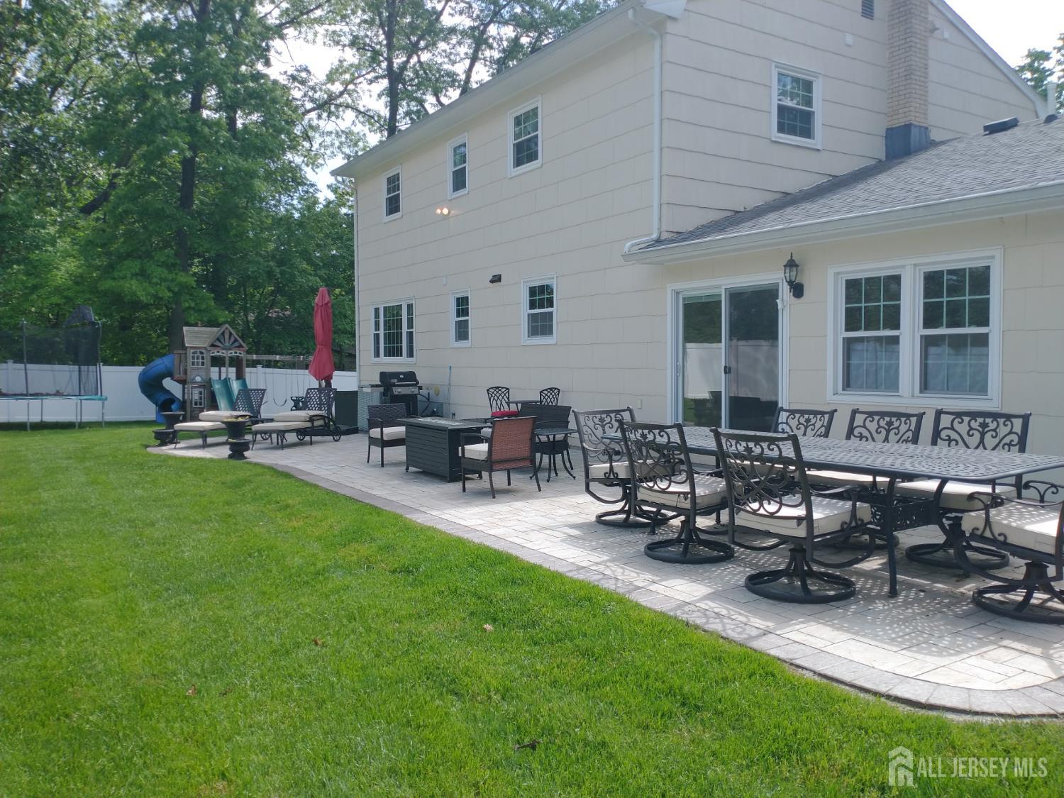 18 Timber Road East Brunswick, NJ 08816 - Photo 30 of 38 a backyard of a house with table and chairs