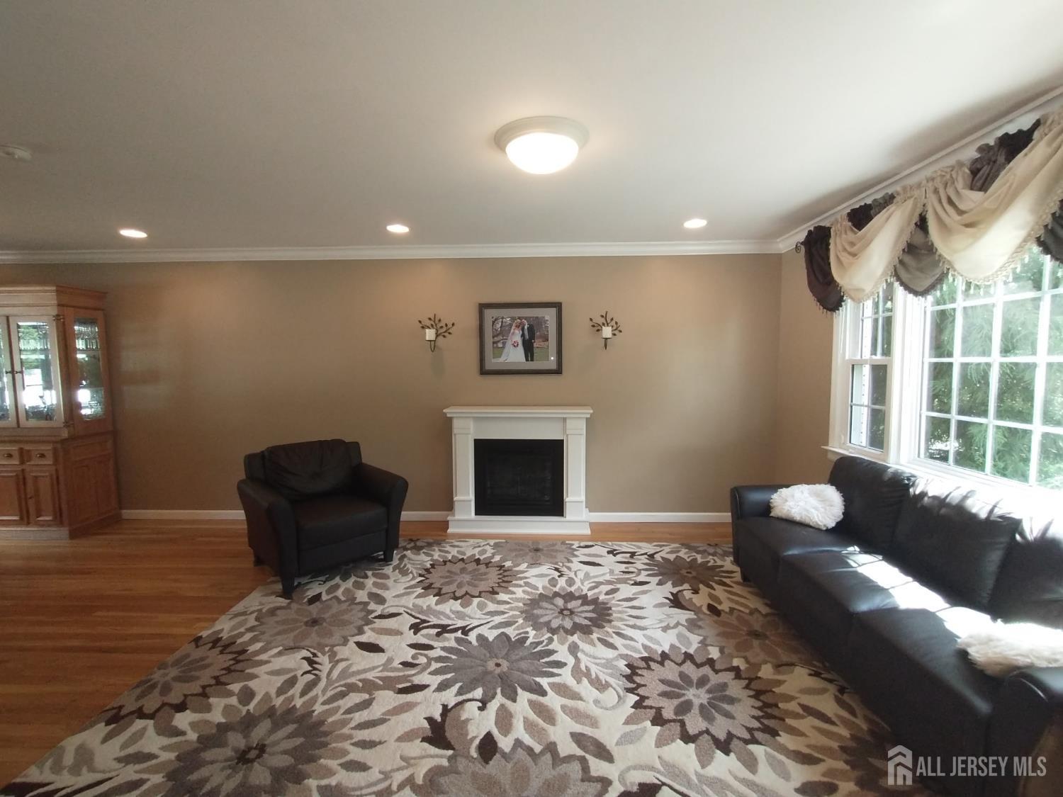 18 Timber Road East Brunswick, NJ 08816 - Photo 4 of 38 a living room with furniture a fireplace and a large window