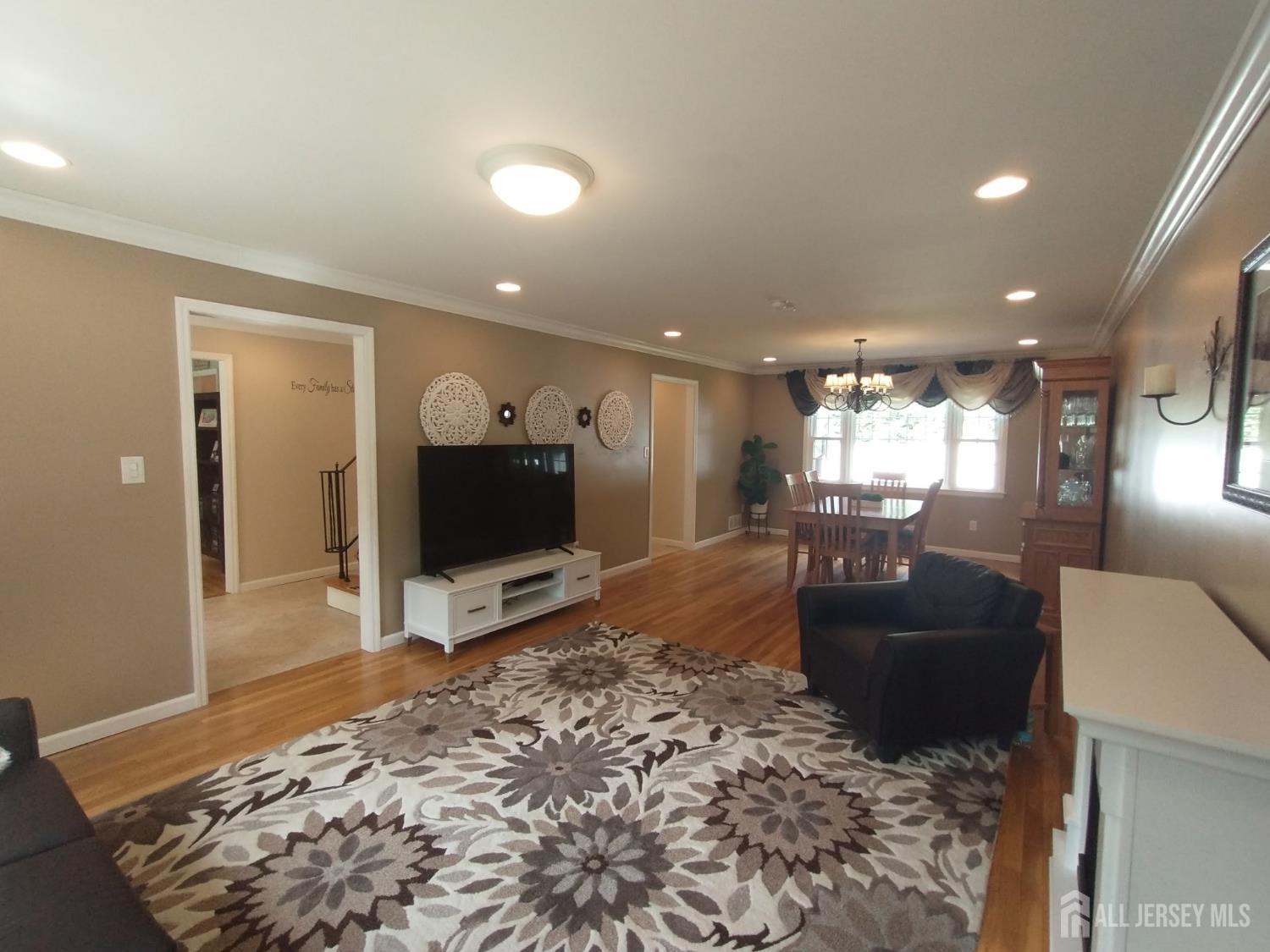 18 Timber Road East Brunswick, NJ 08816 - Photo 6 of 38 a living room with furniture and a flat screen tv