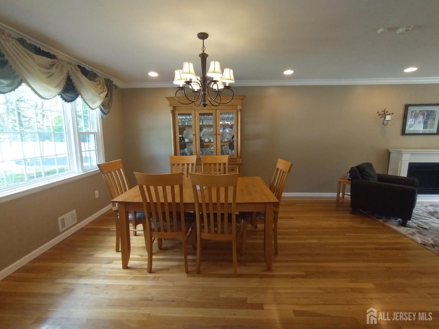 18 Timber Road East Brunswick, NJ 08816 - Photo 7 of 38 a view of a dining room with furniture a chandelier and wooden floor